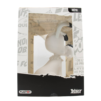 Linke Seitenansicht der Idefix Figur von Plastoy in der Originalverpackung mit grauen Comicmotiven und dem Asterix-Logo.